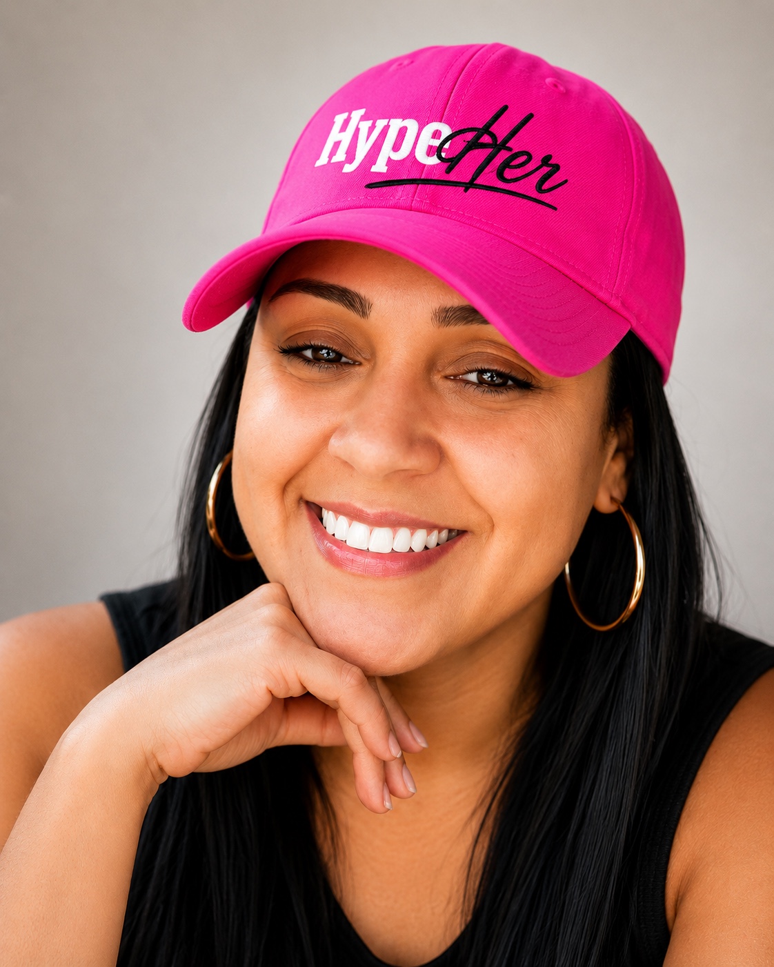 Lameisha Sherri smiling in a hot pink HypeHer® cap.